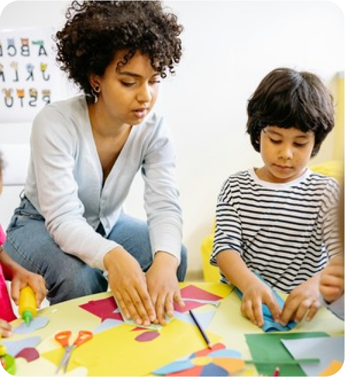 Teacher and preschool student working
