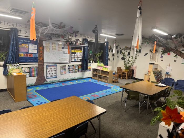 two kids play with a bear