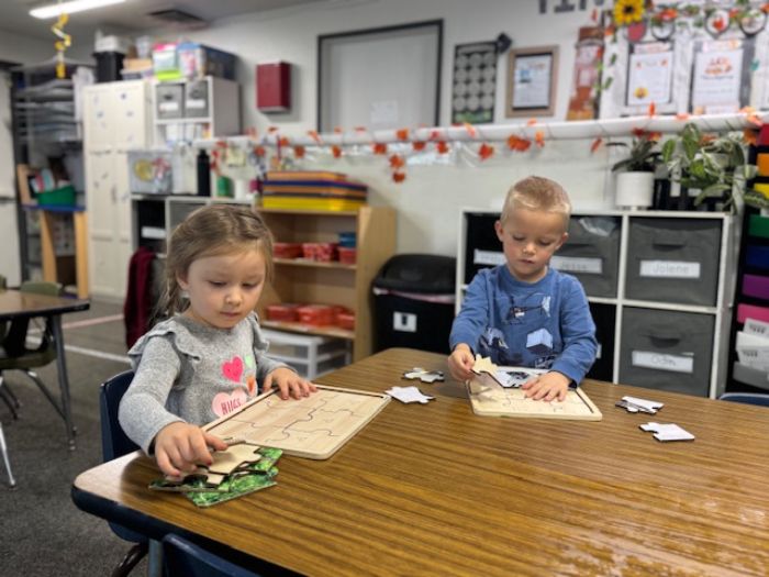two kids playing in a sandbox